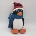 Organic cotton penguin, handknitted from soft 100% organic cotton, wearing Santa hat and teal green scarf, made in USA