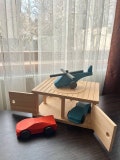 Set of wooden toys: garage, two sports car, helicopter. Toys for the development of children's motor skills with moving elements.